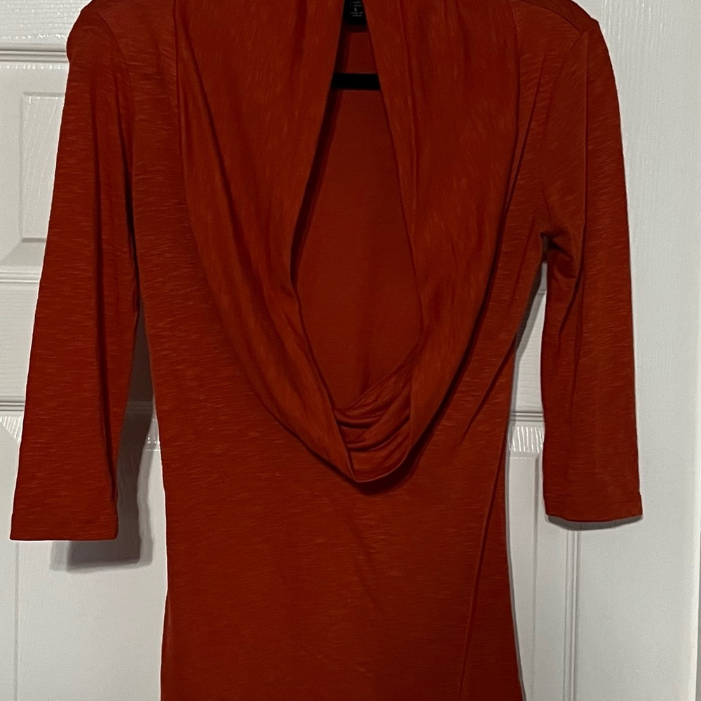 Women’s Orange cowl neck blouse with deep opening in front.